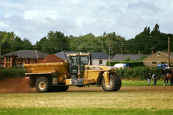 An image of us spreading lime on a field